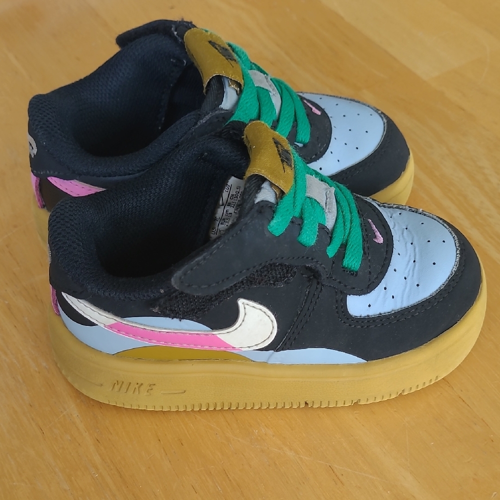 Nike Kids' Black and Gold Sneakers with Pink Accents